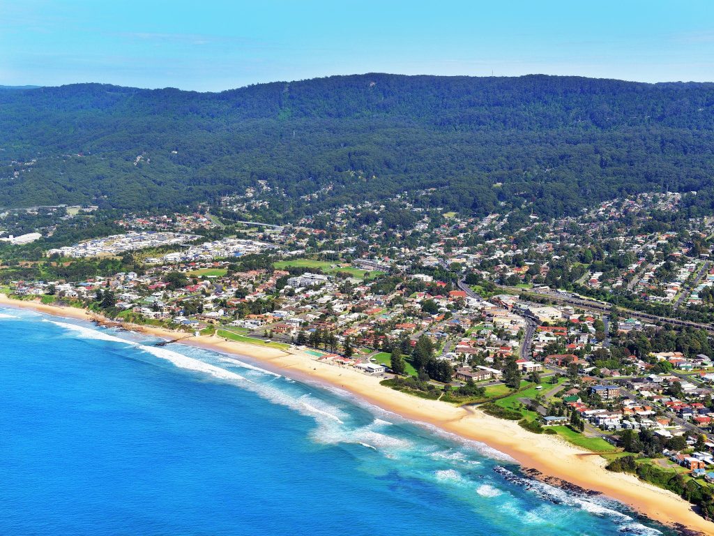 Beach with suburbs and mountain in background